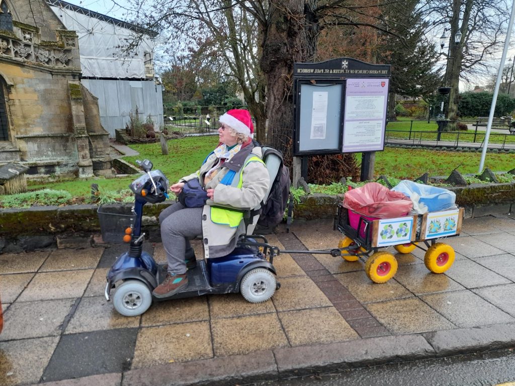 Alexia touring Wisbech on her mobility scooter with her trailer for litter picking and separating rubbish and recycling. 